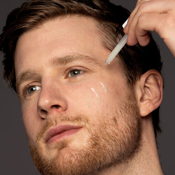 a man applying the serum to his face