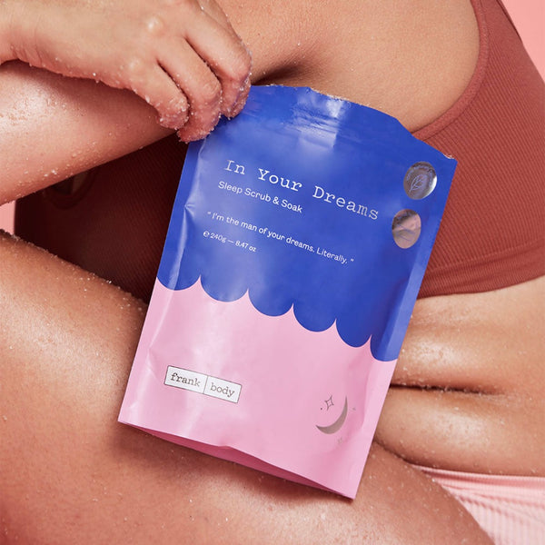 Frank Body In Your Dreams Sleep Scrub and Soak packaging held in front of a person 