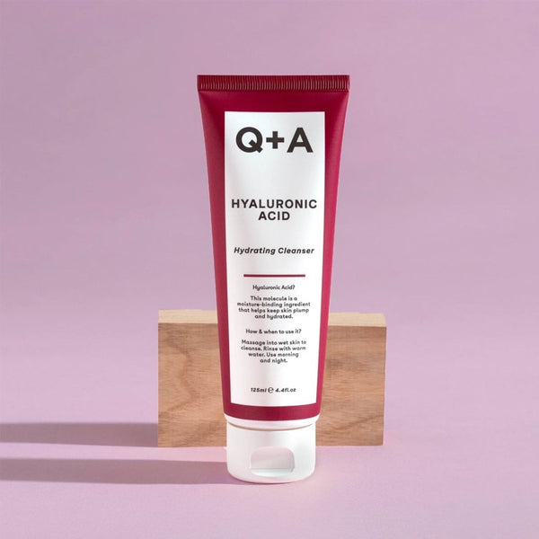 Q+A Hyaluronic Acid Gel Cleanser in front of a wooden block