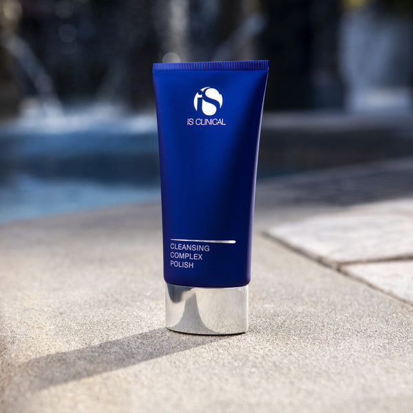 iS Clinical Cleansing Complex Polish placed beside a pool