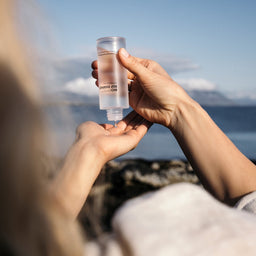 BIOEFFECT EGF Essence being poured into a hand on a beach