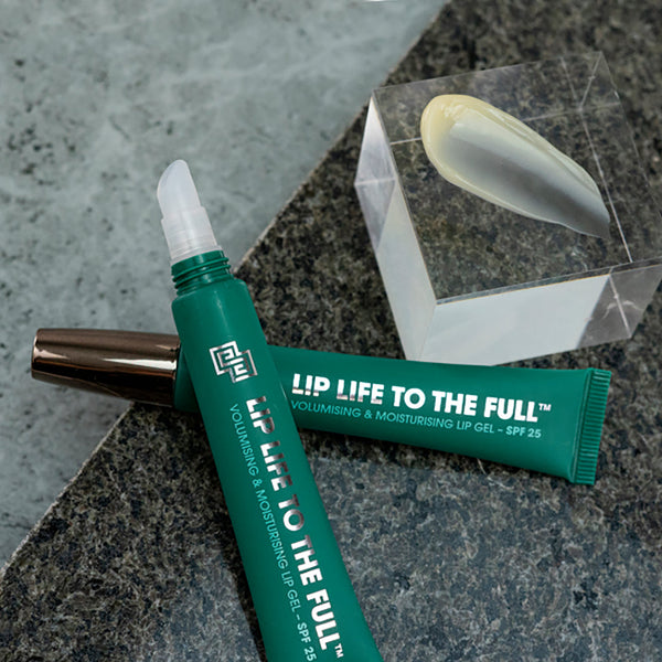 two tubes of Shakeup Cosmetics Lip Life To The Full on a marble surface
