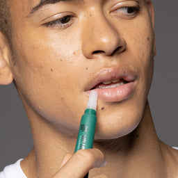 a man applying Lip Life To The Full to his lips