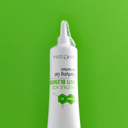 Spot gel emerging from white tube on green background