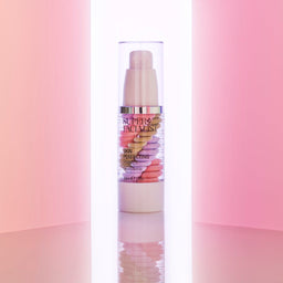 Primer pump bottle emerging from two pink walls 